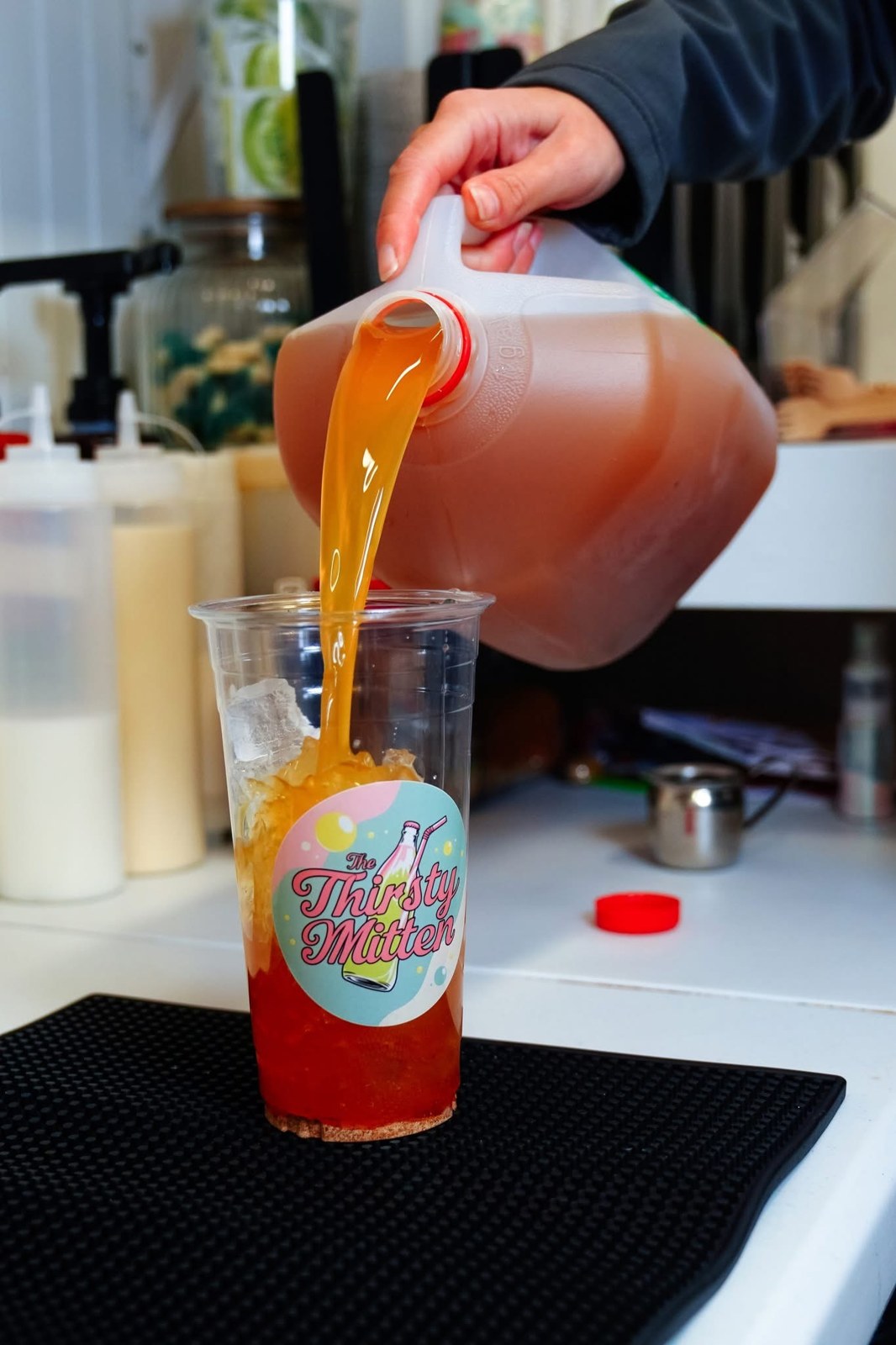 A specialty drink being mixed behind the counter